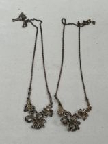 A pair of silver and marcasite necklaces.