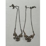 A pair of silver and marcasite necklaces.