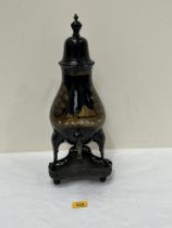 A 19th Century toleware coffee urn on stand, painted in gilt with a landscape. 17½" high.