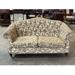 A Victorian sofa with buttoned back and arms. 62" wide.