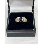 An 18ct sapphire and diamond ring. 6.6g gross. Size L.