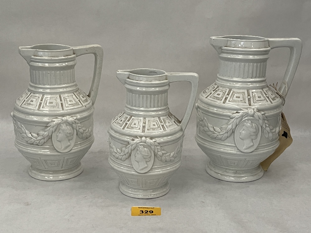 A set of three 19th Century neo-classical white glazed jugs. 8" high and smaller.