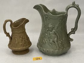 Two Victorian jugs with moulded relief decoration, the drab glazed example by Ridgway. 9" high and