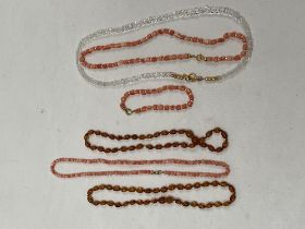 Five necklaces and a bracelet in coral, rock crystal and amber.
