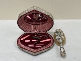 A Lador musical vanity box and an abalone shell parquetry hair brush.