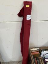 A roll of red sateen fabric. 5'9" x 4'.