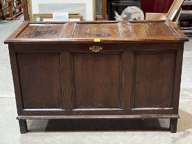 An 18th Century joined oak three panel chest, on stiles.