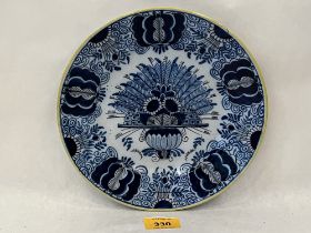 An 18th Century Delft dish decorated in blue and white with foliage. 9" diam.