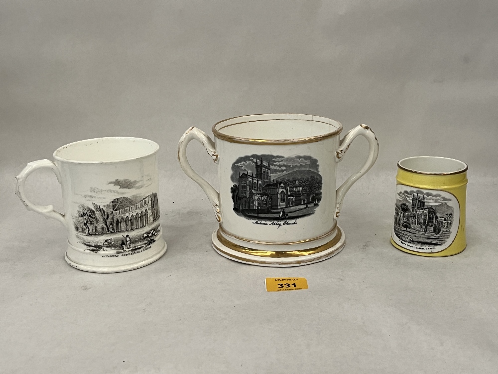 A 19th Century loving cup and two mugs, all transfer printed with views of Malvern or Shropshire.