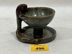 An Oriental glazed pottery bowl or lamp, with anthropomorphic handle. 3" high.