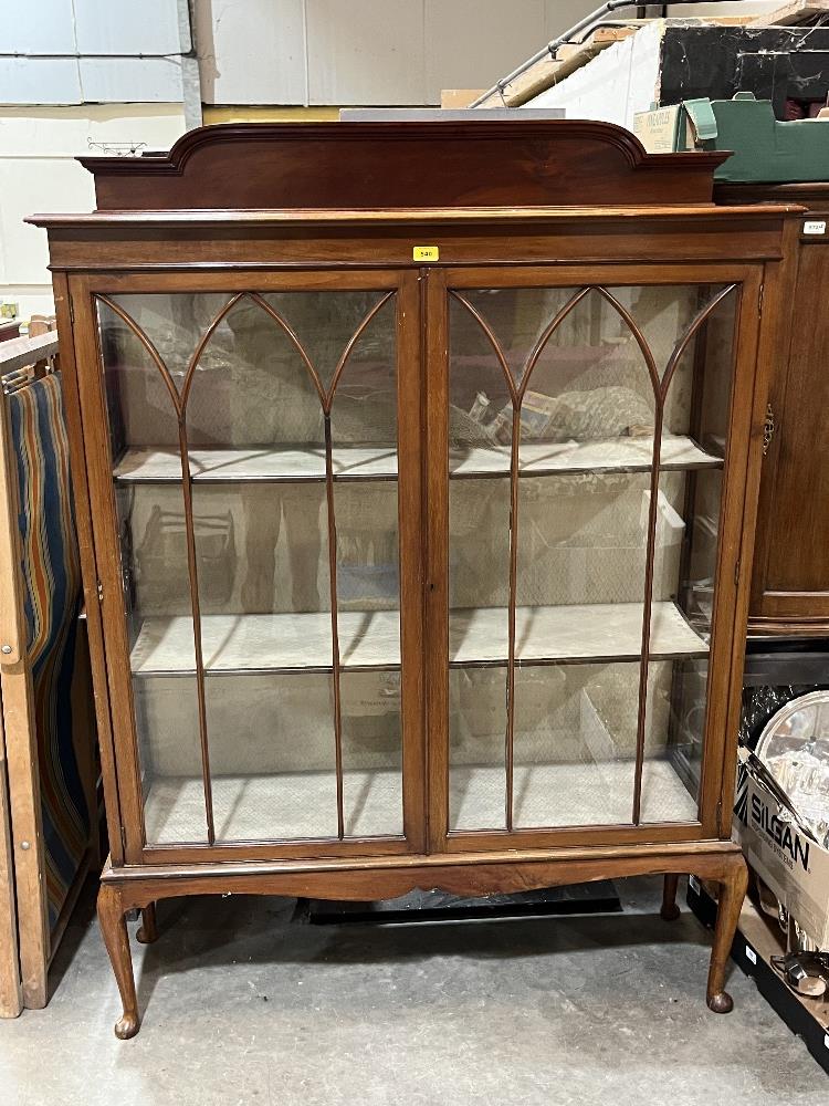 A 1920s mahogany display cabinet enclosed by a pair of astragal glazed doors. 48" wide.