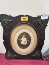 A Victorian oak framed photograph of a young child. 12½" high.