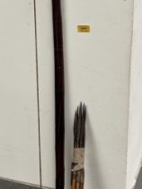 A treen longbow, 63" long, with eight spear tip arrows