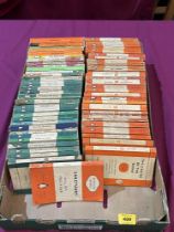 A box of orange and green Penguin books.