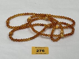 A necklace of alternating clear and egg yolk amber beads. 44½" long, 24g.