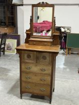 A Victorian dressing chest by Heal & Son, London; enclosed by a pair of patera carved doors over