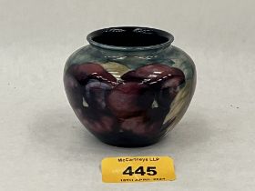 A Moorcroft violet pot with tube-lined pansies. 2¼" high.