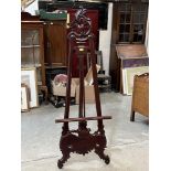 A carved wood easel of recent manufacture. 67" high