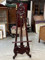 A carved wood easel of recent manufacture. 67" high