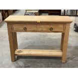 A light oak side table. 39½" wide.