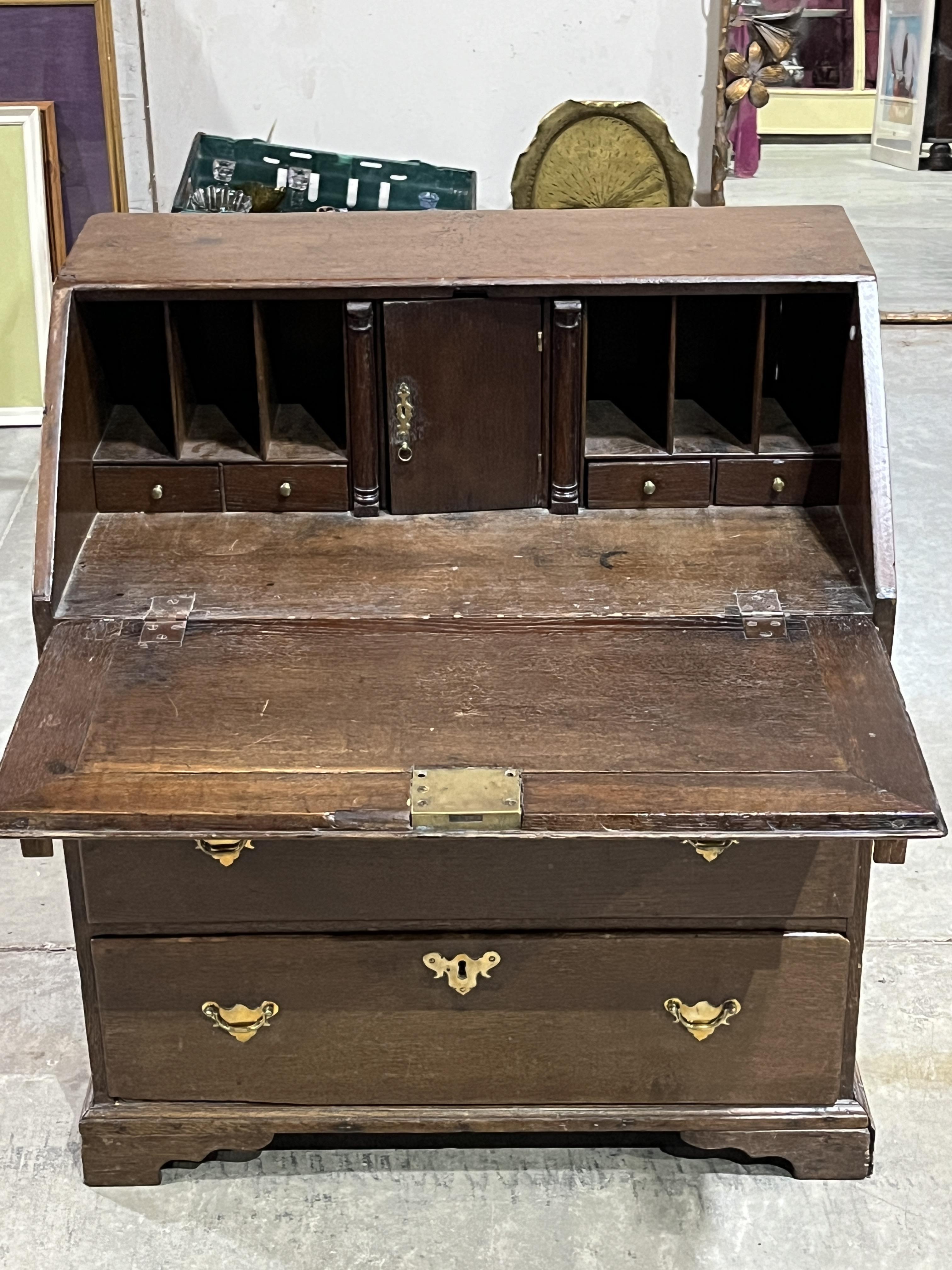 An 18th Century oak bureau with fitted interior over three drawers on bracket feet. 30½" wide - Image 2 of 2