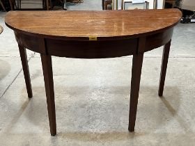 A 19th Century mahogany demi-lune side table on square tapered legs. 48" wide.