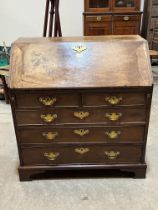 A George III mahogany bureau with fitted interior, on later bracket feet. 36" wide.