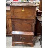 An early 20th Century mahogany side cabinet with brass gallery over fall front. 21" wide.