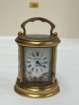 A French gilt brass carriage timepiece, signed Elliott and Son, London, with painted porcelain