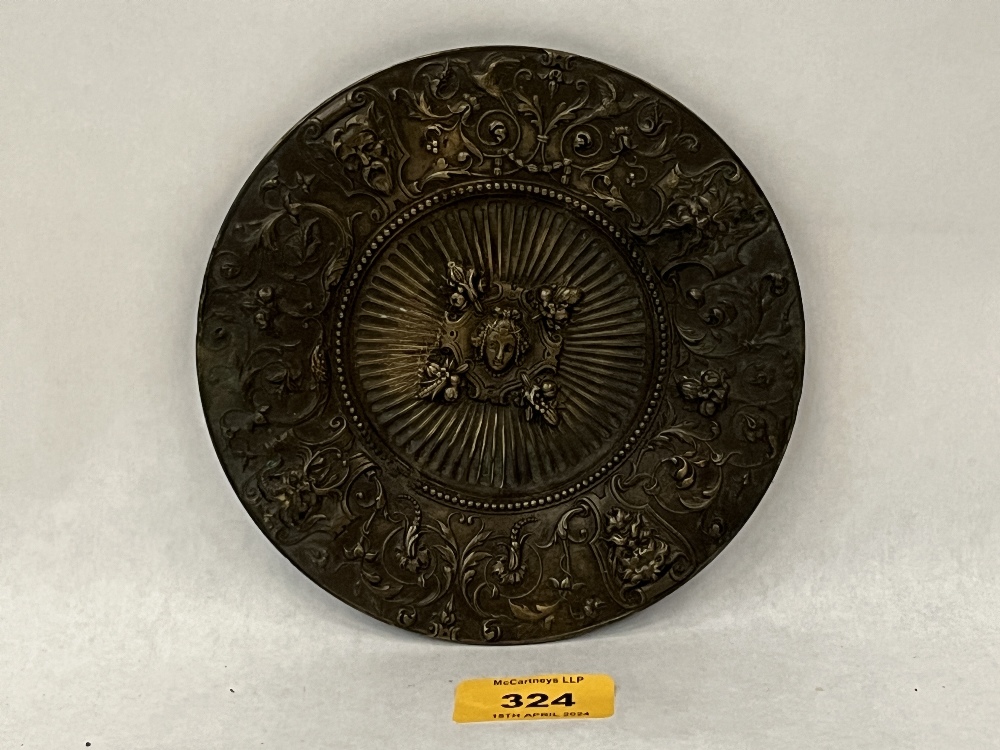 A 19th Century bronze dish, cast in relief with masks and trailed foliage. 6" diam.