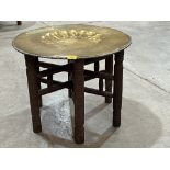 An Indian folding table with brass benares tray top.