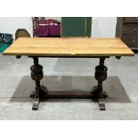 An oak refectory style dining table on carved cup and cover end support. 54" long