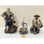 Three Chinese polychrome glazed Mudman figures, the largest 10" high.