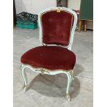 An antique French Louis XV salon chair on cabriole legs.