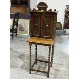 A Victorian walnut mural cupboard enclosed by a pair of blind fret carved doors, 24" high,