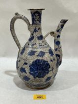 A Turkish Ottoman blue and white decorated ewer, 9¾" high. Rim chips.