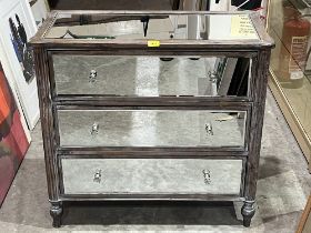 A decorated chest of drawers with mirror plates to top, sides and drawer fronts. 33" wide. Crack