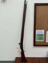 An antique flintlock musket. 58½" long.