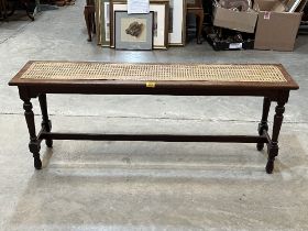 A Victorian mahogany window seat with caned seat, on turned legs. 52" wide.