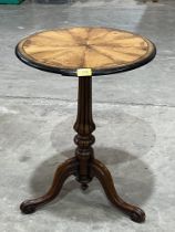 A Victorian walnut lamp table on tripod support. 17" diam