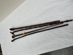 Four 19th Century carved treen walking sticks.