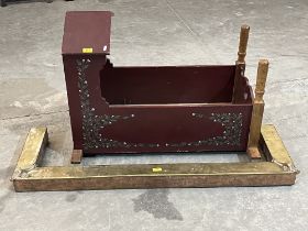 A painted cradle and a brass fire curb.