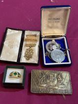 A silver gilt masonic jewel; a Rolls-Royce belt buckle; a dress ring and two medallions.