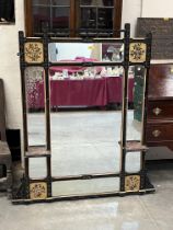 A Victorian ebonised "aesthetic" overmantle mirror with four gilded panels painted with flowers.