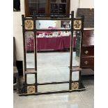 A Victorian ebonised "aesthetic" overmantle mirror with four gilded panels painted with flowers.