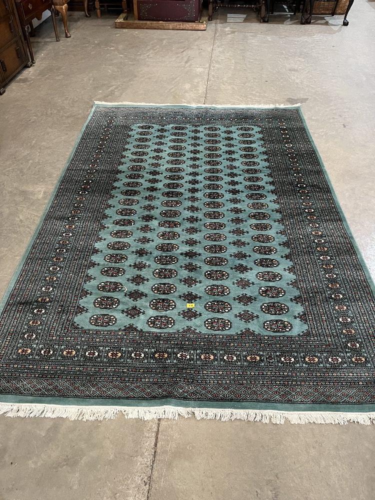 A blue ground Eastern style wool carpet. 110" x 75".