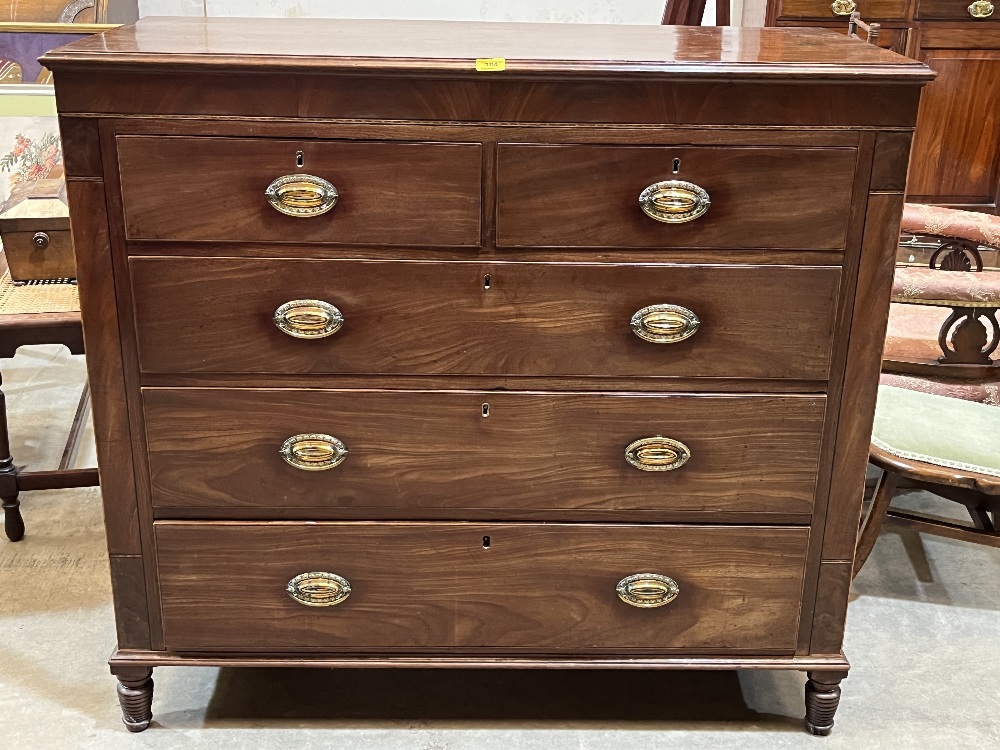 A George III mahogany chest of drawers raised on turned feet. 47" wide.