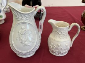 Two Victorian relief decorated parian jugs, the larger 8" high.