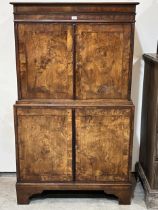 A George I and later walnut cabinet in two parts, the upper fitted with pigeonholes, eight