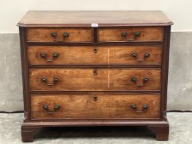 A George III mahogany chest with moulded canted top and reeded canted sides, the two short over